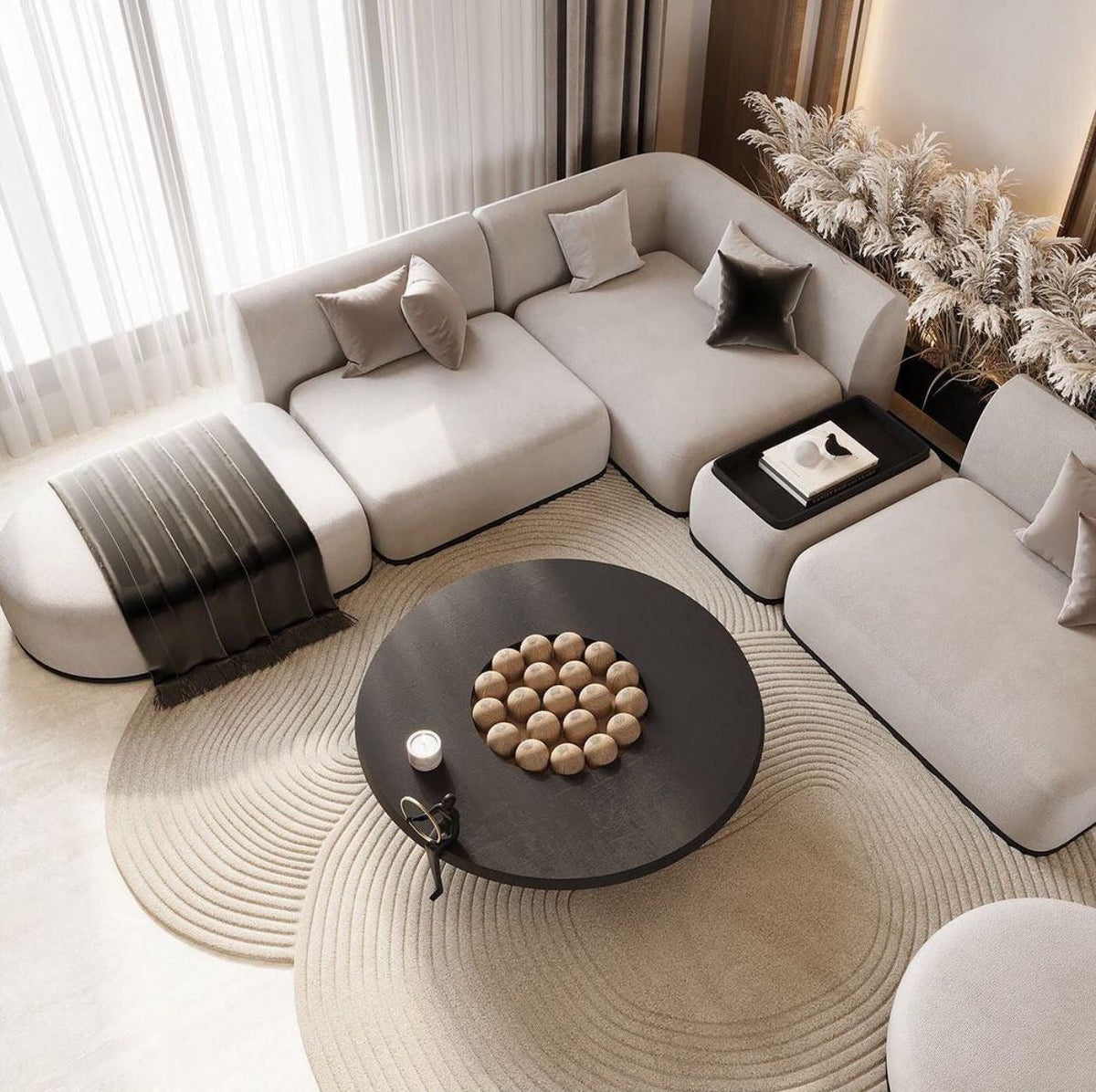 Modern living room with a large round rug, sofa, coffee table, and decorative elements.