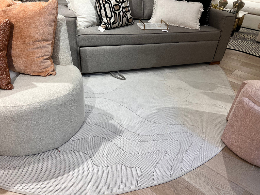 Ivory Indoor/Outdoor Rug with Organic Irregular Shape and Warm Mocha Accents.