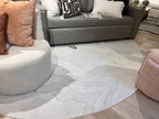 Ivory Indoor/Outdoor Rug with Organic Irregular Shape and Warm Mocha Accents.