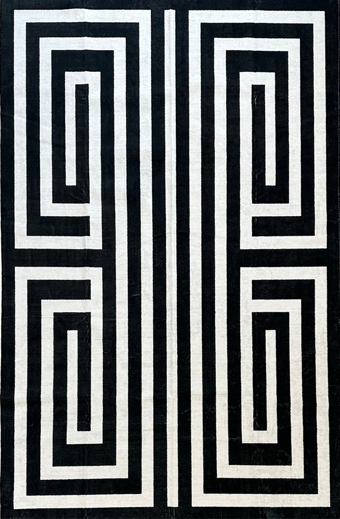 Black and white geometric pattern on a textured fabric background