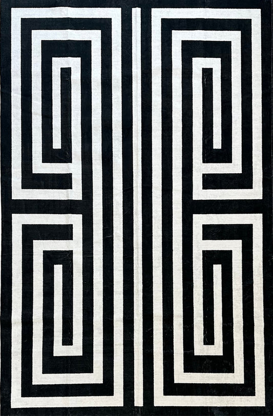 Black and white geometric pattern on a textured fabric background
