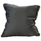Black pillow with frayed edges on a white background