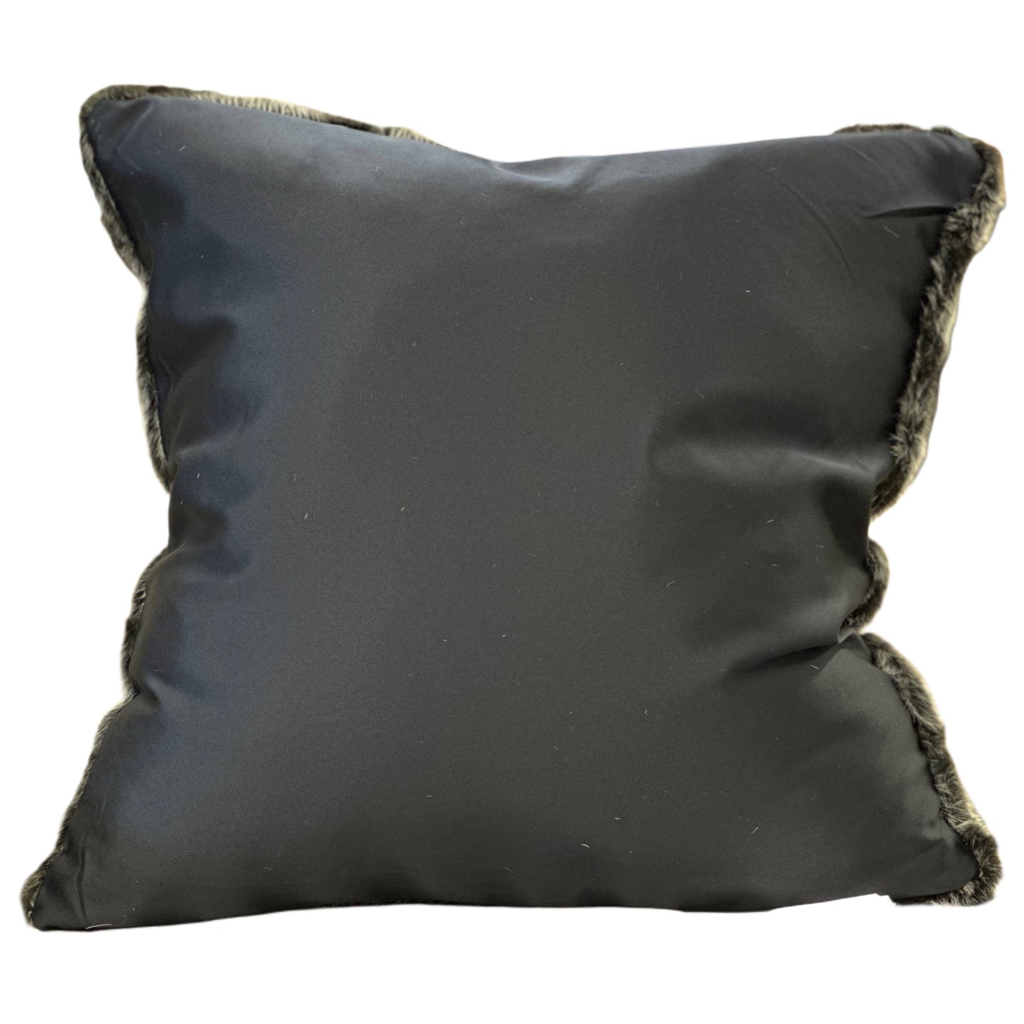 Black pillow with frayed edges on a white background