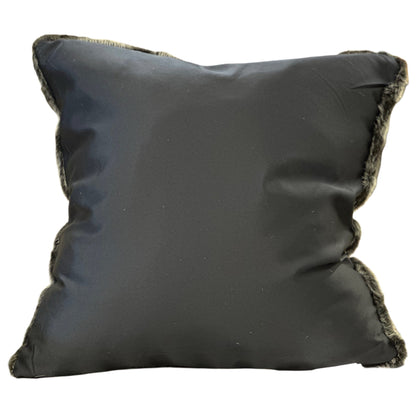 Black pillow with frayed edges on a white background
