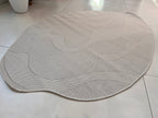 Ivory Indoor/Outdoor Rug with Organic Irregular Shape and Warm Mocha Accents.