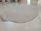 Ivory Indoor/Outdoor Rug with Organic Irregular Shape and Warm Mocha Accents.