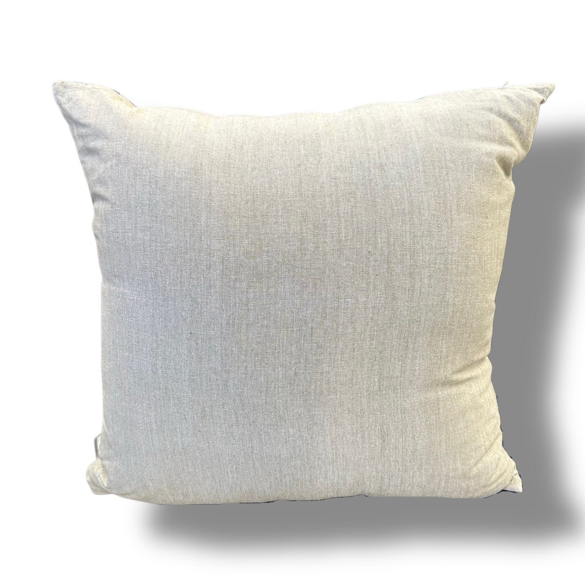 A square throw pillow in a light beige linen fabric, shown against a plain white background with a soft drop shadow.