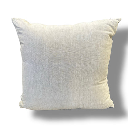 A square throw pillow in a light beige linen fabric, shown against a plain white background with a soft drop shadow.