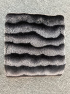 Textured gray square mat on a textured surface
