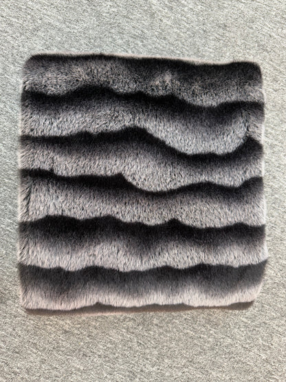 Textured gray square mat on a textured surface
